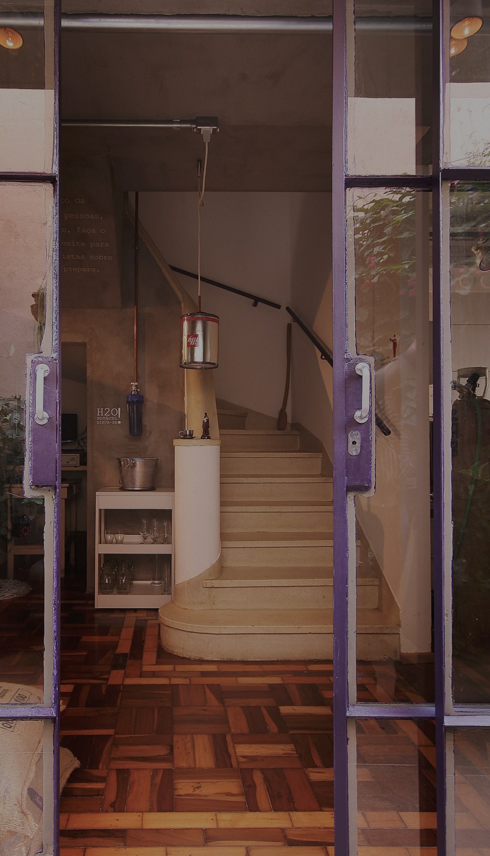 The entrance and spiral staircase at Coffee Lab, seen through its purple framed doors